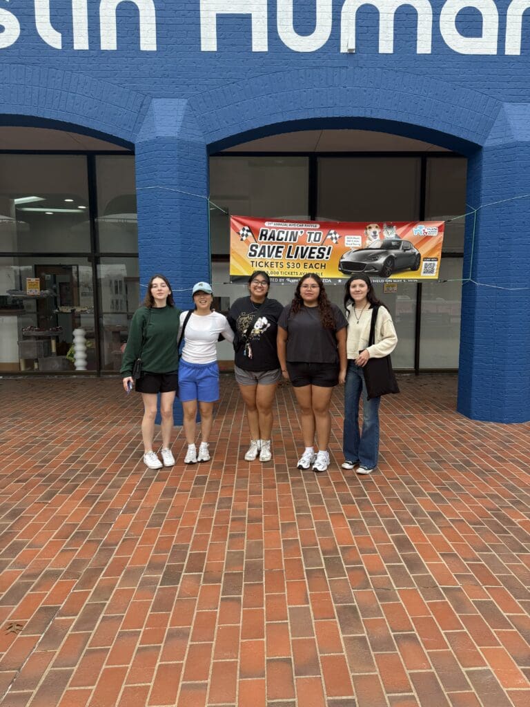Four women standing in front of a building.