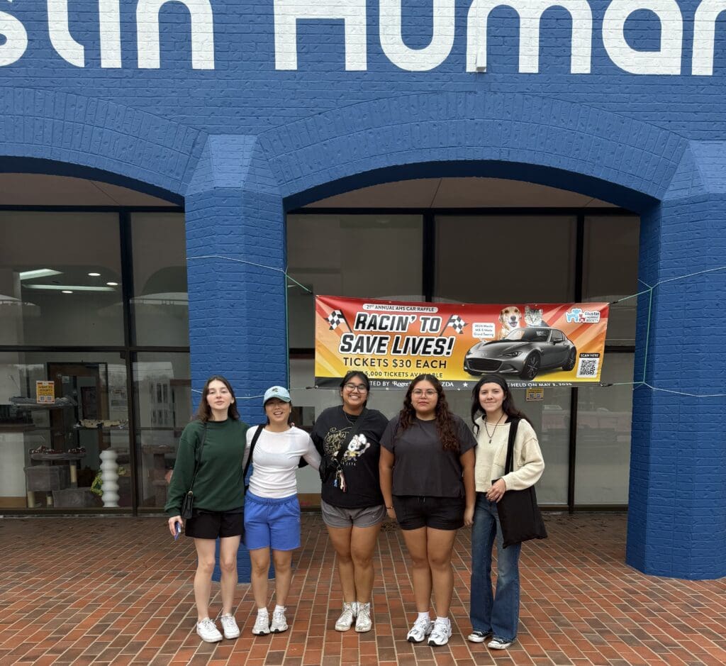 Four women standing in front of a building.